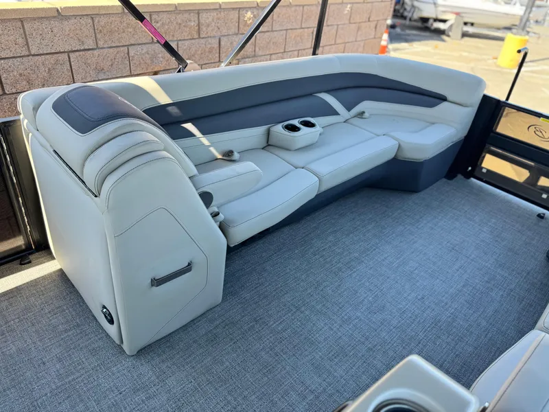 Slide: The Image of 2023 Barletta Cabrio 24UC boat interior with plush seating and cup holders. - 10