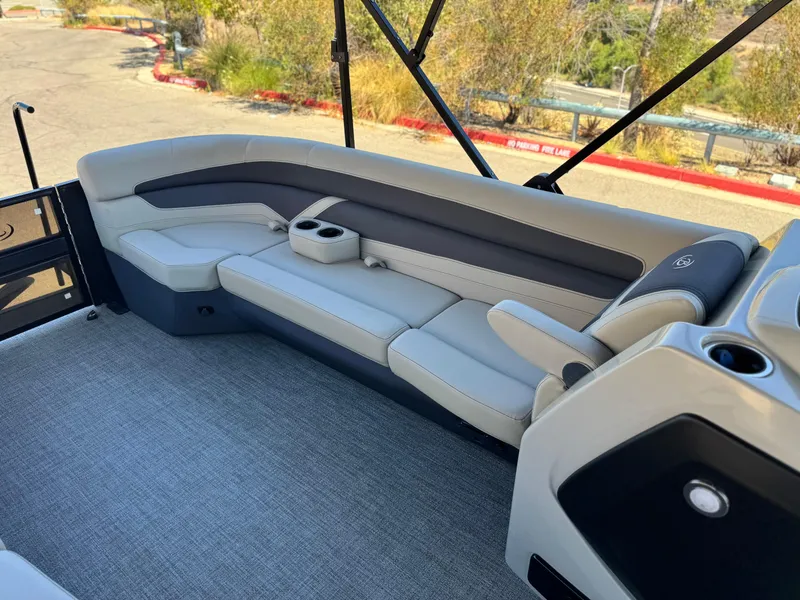 Slide: The Image of 2023 Barletta Cabrio 24UC boat interior with plush seating and cup holders. - 11