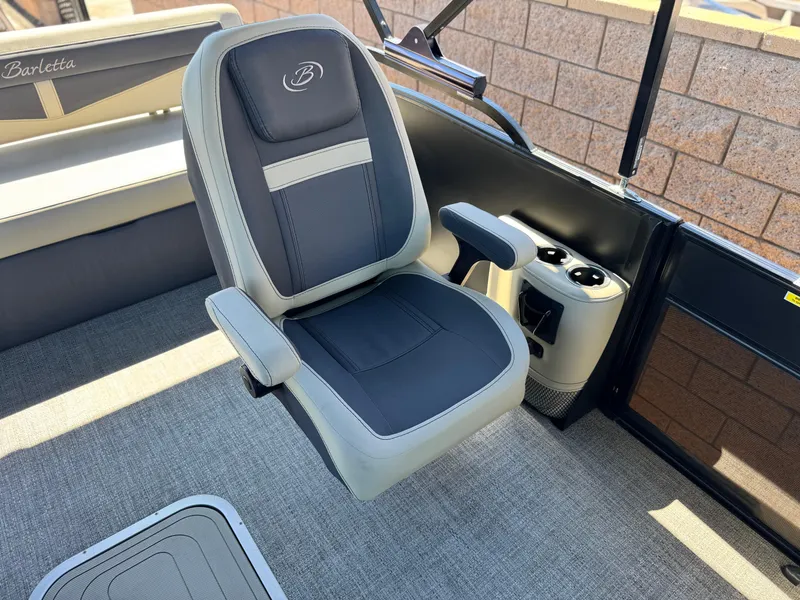 Slide: The Image of 2023 Barletta Cabrio 24UC boat interior with captain's chair and cup holders. - 13