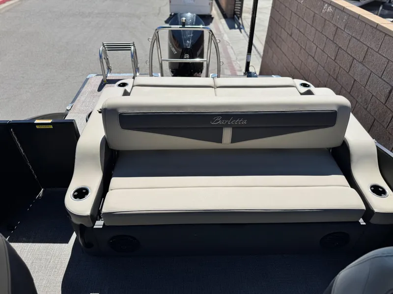 Slide: The Image of 2023 Barletta Cabrio 24UC boat with beige seating and cup holders. - 15
