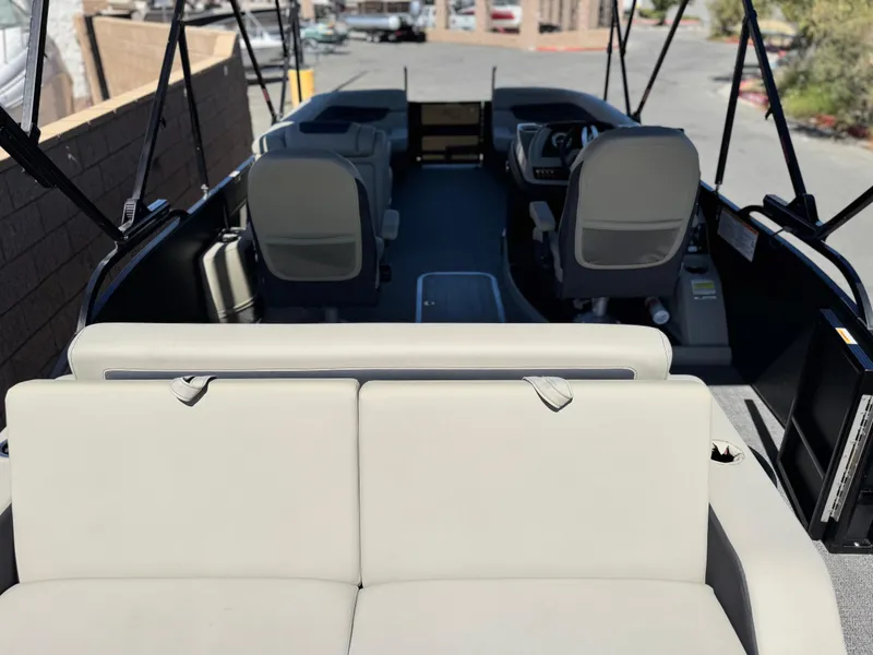 Slide: The Image of 2023 Barletta Cabrio 24UC pontoon boat interior with seating and helm. - 19