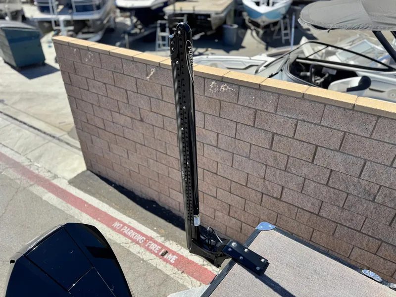 Slide: The Image of 2023 Barletta Cabrio 24UC boat detail at marina, featuring a Power-Pole anchor. - 21