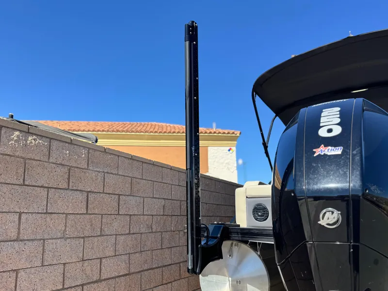 Slide: The Image of 2023 Barletta Cabrio 24UC boat engine and power pole against a brick wall. - 22