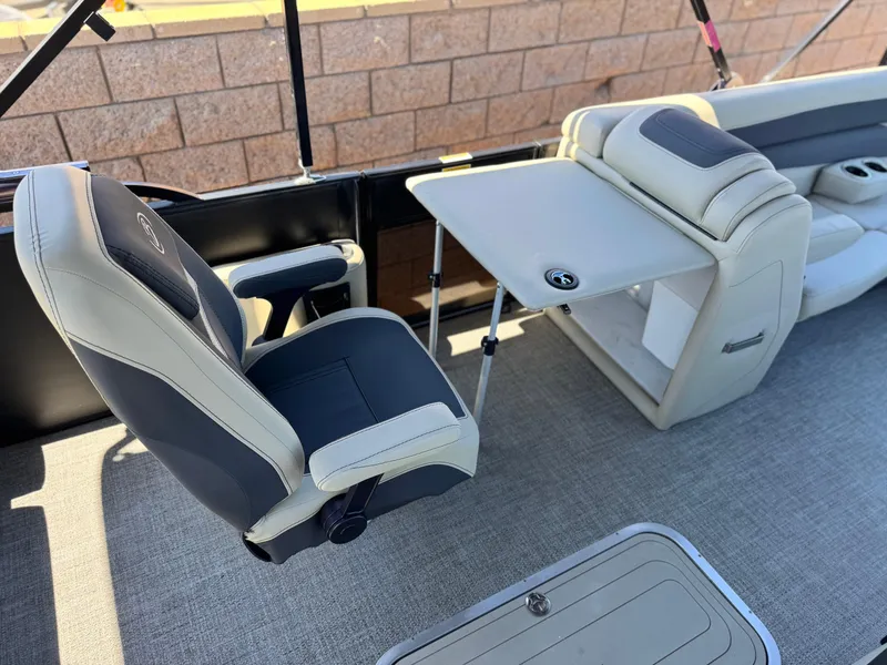 Slide: The Image of 2023 Barletta Cabrio 24UC boat interior with luxurious seating and table setup. - 24