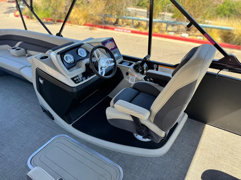 Slide: The Image of 2023 Barletta Cabrio 24UC boat interior with steering console and captain's chair. - 27