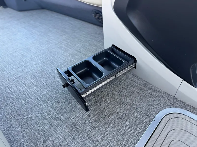 Slide: The Image of 2023 Barletta Cabrio 24UC interior with pull-out cup holder on carpeted floor. - 30