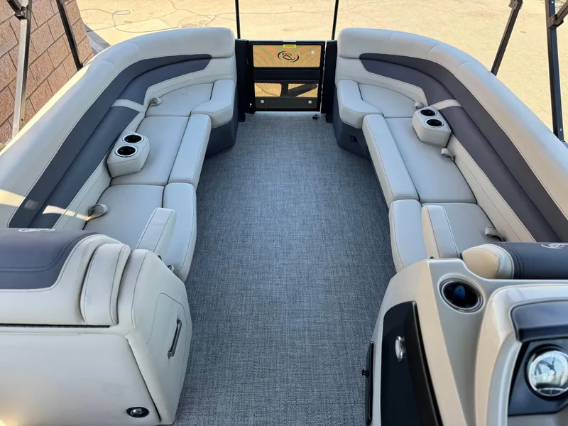 Slide: The Image of 2023 Barletta Cabrio 24UC pontoon boat interior with plush seating and cup holders. - 9
