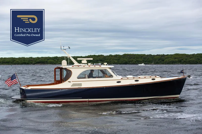 Slide: The Image of 2007 Hinckley Talaria 44 MY yacht on water, certified pre-owned, with American flag. - 0