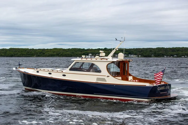 Slide: The Image of 2007 Hinckley Talaria 44 MY cruising on a lake with American flag. - 10