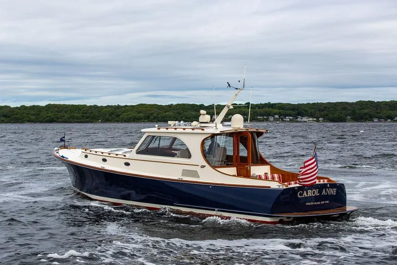 Slide: The Image of 2007 Hinckley Talaria 44 MY yacht cruising on open water, displaying American flag. - 11