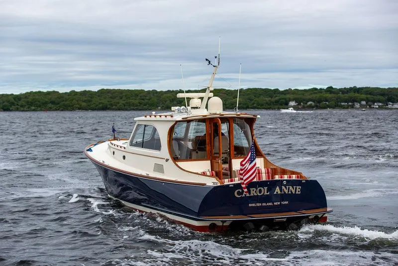 Slide: The Image of 2007 Hinckley Talaria 44 MY yacht cruising on open water, rear view. - 13