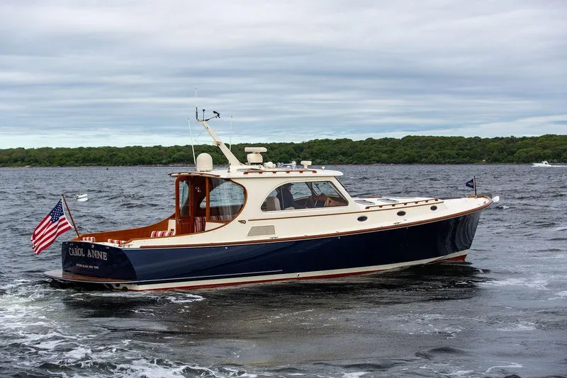 Slide: The Image of 2007 Hinckley Talaria 44 MY yacht cruising on open water with American flag. - 17