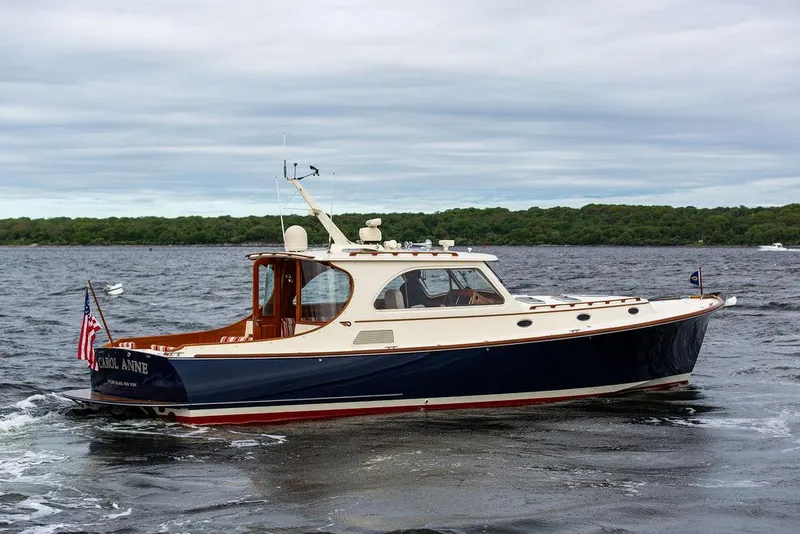 Slide: The Image of 2007 Hinckley Talaria 44 MY yacht cruising on a lake with forested shoreline. - 18