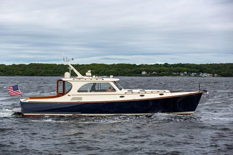Slide: The Image of 2007 Hinckley Talaria 44 MY yacht cruising on a lake with American flag. - 2