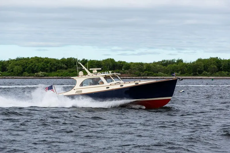 Slide: The Image of 2007 Hinckley Talaria 44 MY cruising on open water, showcasing sleek design and performance. - 22