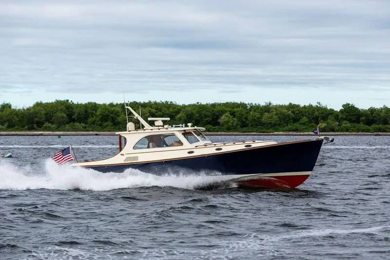 Slide: The Image of 2007 Hinckley Talaria 44 MY cruising on open water with American flag. - 23