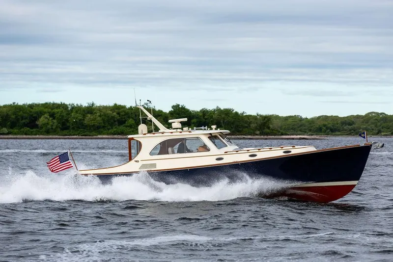 Slide: The Image of 2007 Hinckley Talaria 44 MY cruising on water, American flag waving. - 24