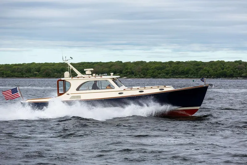 Slide: The Image of 2007 Hinckley Talaria 44 MY cruising on open water, American flag waving. - 26