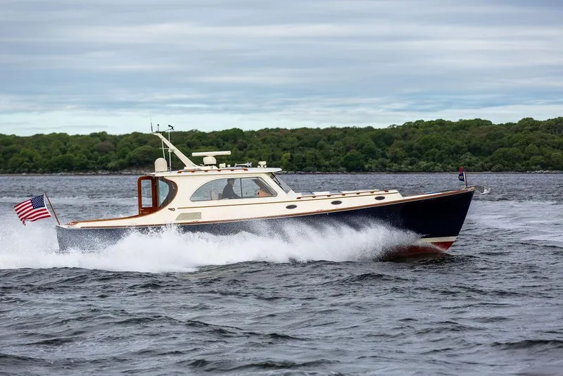 Slide: The Image of 2007 Hinckley Talaria 44 MY cruising on water with American flag. - 27