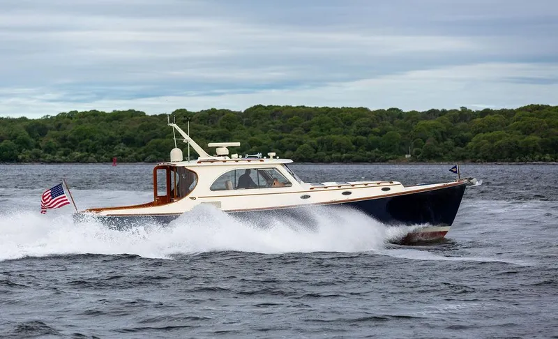 Slide: The Image of 2007 Hinckley Talaria 44 MY cruising on water with American flag. - 28