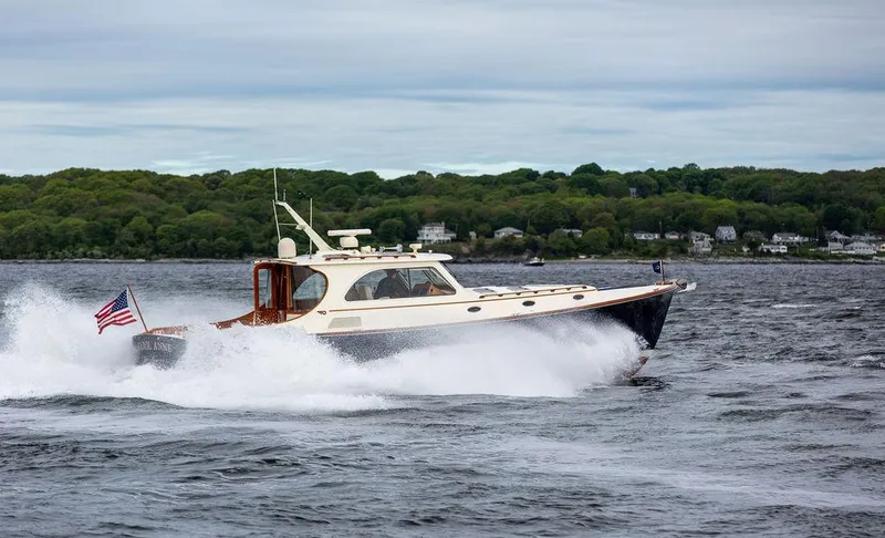 Slide: The Image of 2007 Hinckley Talaria 44 MY cruising on a scenic waterway with lush green shoreline. - 29