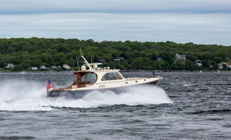 Slide: The Image of Hinckley Talaria 44 MY 2007 cruising on a lake with lush green shoreline. - 30