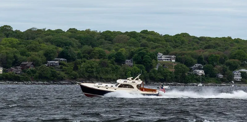 Slide: The Image of 2007 Hinckley Talaria 44 MY cruising on a scenic, tree-lined coastal waterway. - 31