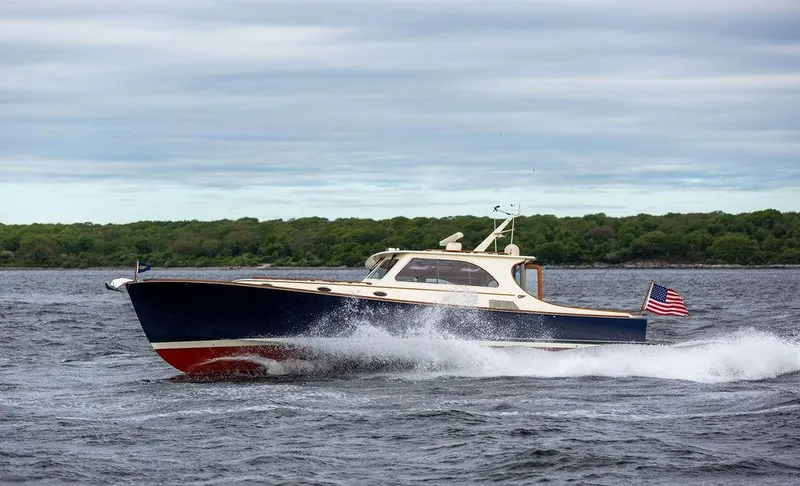 Slide: The Image of 2007 Hinckley Talaria 44 MY cruising on open water with American flag. - 38