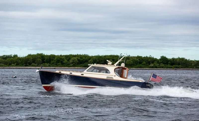 Slide: The Image of 2007 Hinckley Talaria 44 MY cruising on water with American flag. - 39