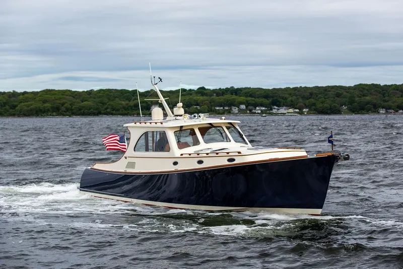 Slide: The Image of 2007 Hinckley Talaria 44 MY cruising on a lake with American flag. - 4