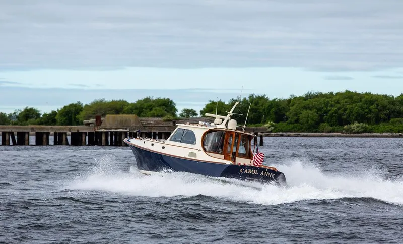 Slide: The Image of 2007 Hinckley Talaria 44 MY cruising on water near a pier. - 41