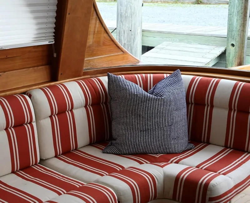Slide: The Image of Interior of 2007 Hinckley Talaria 44 MY with striped seating and decorative pillow. - 43