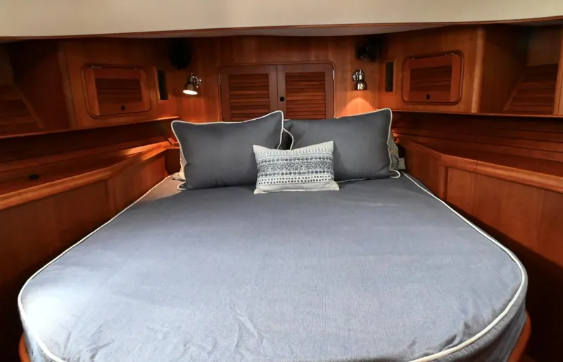 Slide: The Image of Luxurious cabin interior of 2007 Hinckley Talaria 44 MY with cozy bedding. - 44
