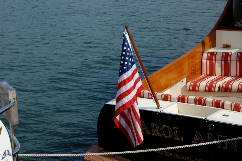 Slide: The Image of 2007 Hinckley Talaria 44 MY yacht with American flag and striped seating. - 48