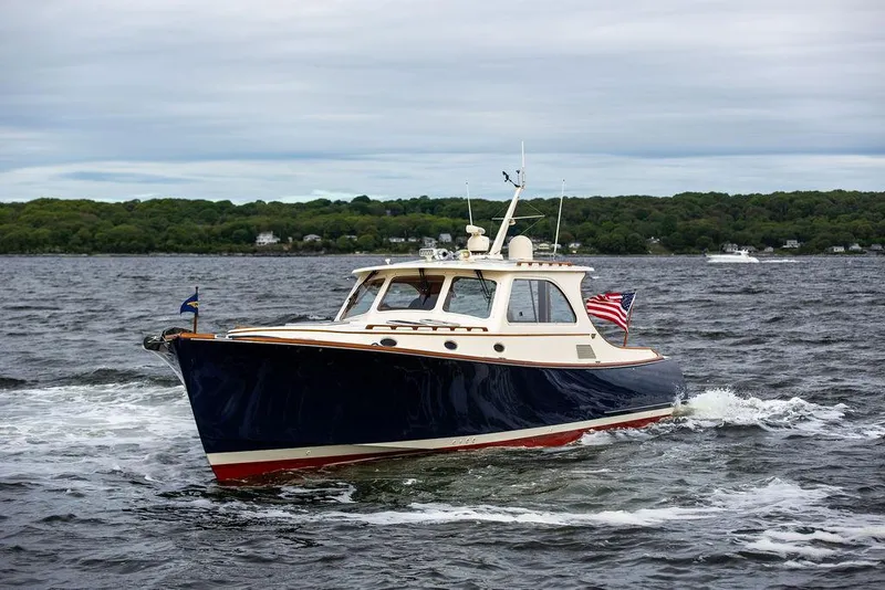 Slide: The Image of 2007 Hinckley Talaria 44 MY cruising on open water with American flag. - 5