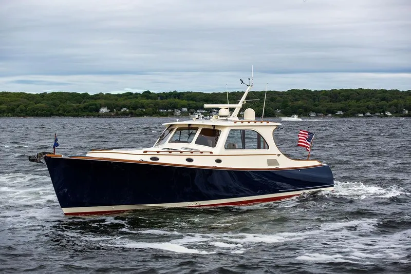 Slide: The Image of 2007 Hinckley Talaria 44 MY cruising on open water with American flag. - 6