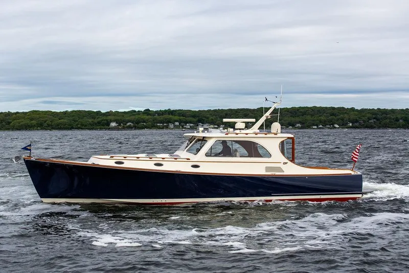Slide: The Image of 2007 Hinckley Talaria 44 MY cruising on open water under cloudy skies. - 8