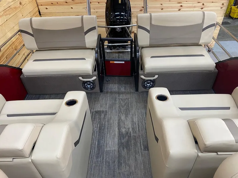 Slide: The Image of 2023 Crest Classic LX 220 SLRC boat interior with beige seating and cup holders. - 7