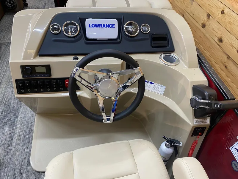 Slide: The Image of 2023 Crest Classic LX 220 SLRC boat dashboard with steering wheel and Lowrance display. - 8