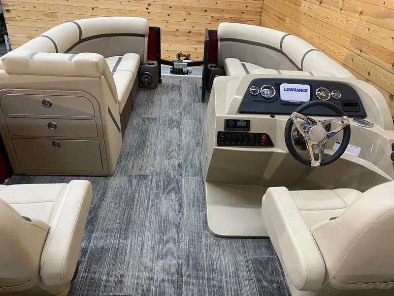 Slide: The Image of 2023 Crest Classic LX 220 SLRC boat interior with beige seating and modern dashboard. - 9