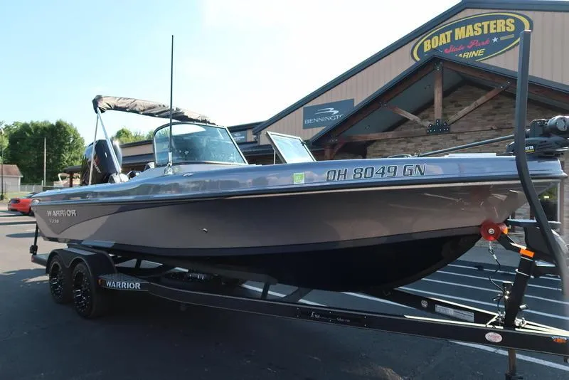 Slide: The Image of 2024 Warrior 238 DC boat on trailer outside Boat Masters Marine store. - 11