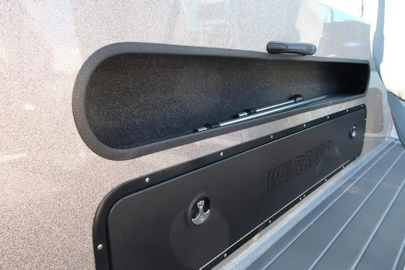 Slide: The Image of 2024 Warrior 238 DC boat storage compartment with sleek design and secure latch. - 18