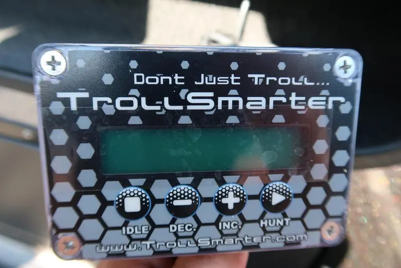 Slide: The Image of Digital trolling motor control panel with hexagonal design, featuring "TrollSmarter" branding. - 24