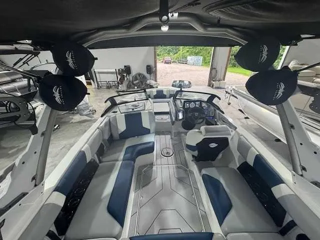 Slide: The Image of 2022 Malibu 21 LX boat interior with modern seating and dashboard design. - 3