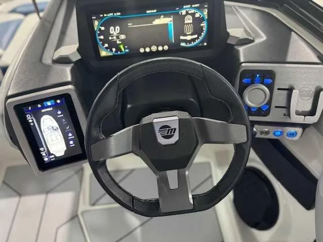 Slide: The Image of Steering wheel and dashboard of 2022 Malibu 21 LX boat with digital displays. - 6
