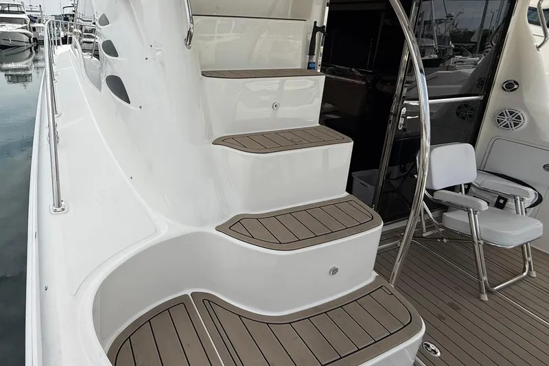 Slide: The Image of 2010 Sea Ray 520 Sedan Bridge yacht with elegant teak steps and seating area. - 13