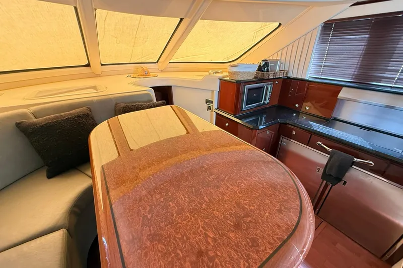 Slide: The Image of Luxurious interior of 2010 Sea Ray 520 Sedan Bridge yacht with elegant wood finishes. - 17