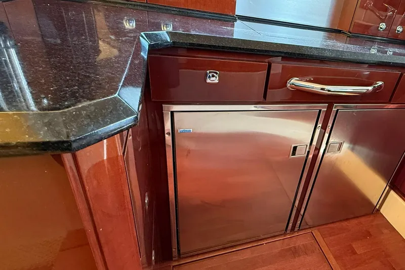 Slide: The Image of Luxurious kitchen area in 2010 Sea Ray 520 Sedan Bridge yacht with sleek cabinetry. - 19