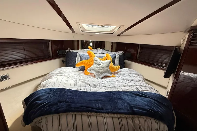 Slide: The Image of Luxurious bedroom interior of 2010 Sea Ray 520 Sedan Bridge yacht with plush bedding. - 20