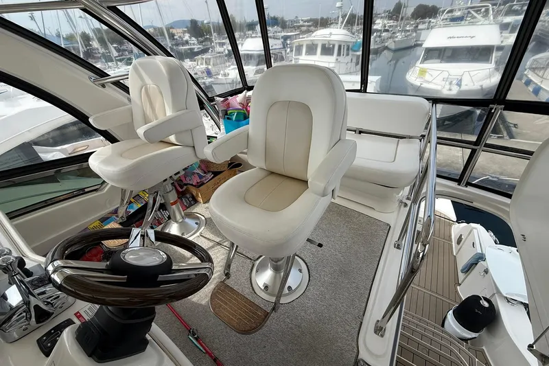 Slide: The Image of Interior of 2010 Sea Ray 520 Sedan Bridge yacht with helm and seating area. - 6